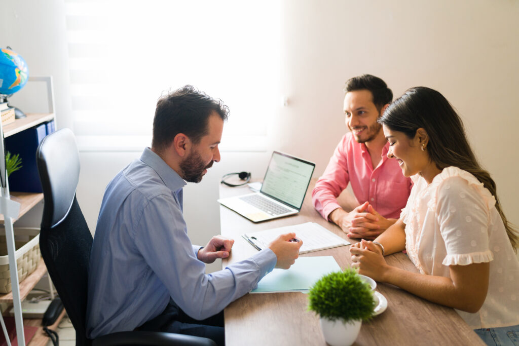 Couple meeting with a local insurance agent to review coverage options.